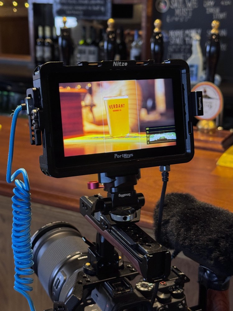 A colour-graded shot and waveform scope shown on the reference monitor during an Adam Drake Studio edit